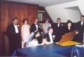 The Rabbi (yes, she is a female Rabbi) is reviewing the text of the ketubah (wedding agreement) after it has been signed. The little boy standing next to Yevgeniya is her three-year-old brother, Edward. Both sets of parents and the groomsmen are visible behind the table., 870x595, 68 Kb